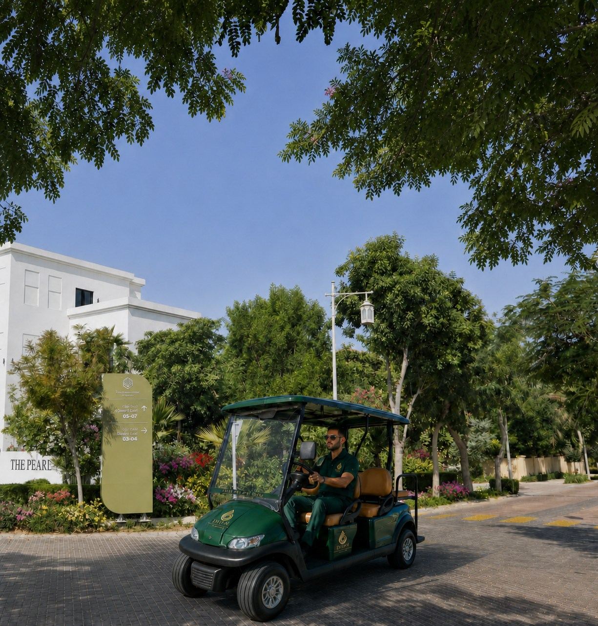 DANA buggy on a tree-lined Al Barari street